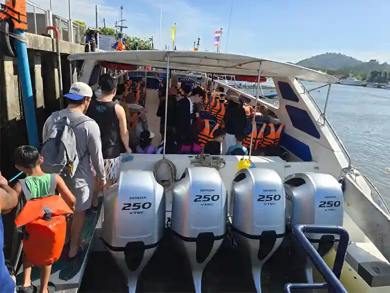 Interior seating of a fast speedboat from Phuket showing compact forward-facing seats and open-air sides for sea breeze.